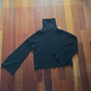 Size XS black turtle neck cropped thin sweater with bell sleeves.